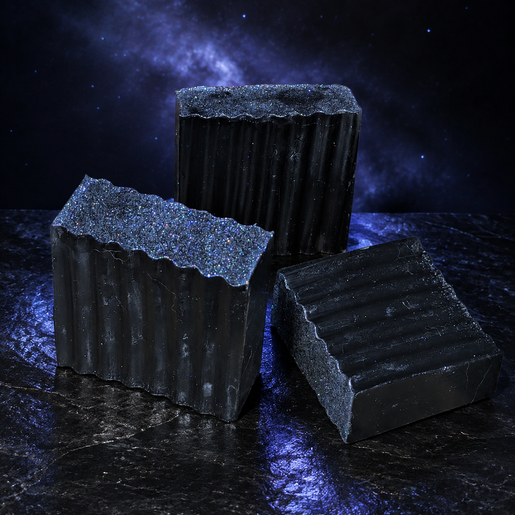 Three Galaxy Glitter handcrafted black soap bars in a dark cosmic product scene