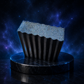 Galaxy Glitter handcrafted black soap with blue holographic glitter on a dark cosmic pedestal